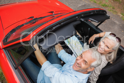 High angle view of cheerful mature man having a ride with his wi