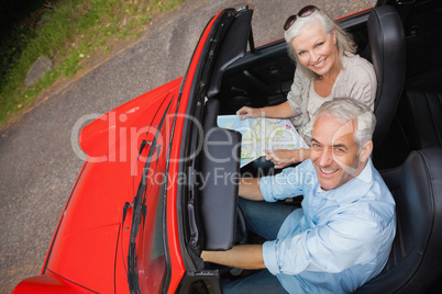 High angle view of smiling mature man having a ride with his wif