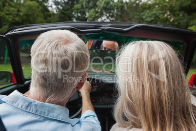 Rear view of mature couple going for a ride together