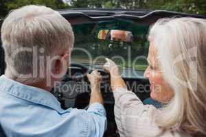 Rear view of smiling mature couple going for a ride together