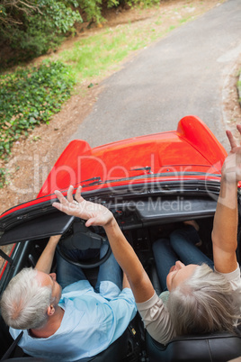 Overhead view of happy mature couple going for a ride together