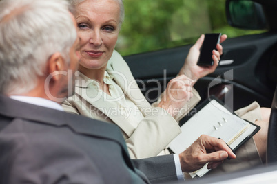 Business people talking together in classy cabriolet