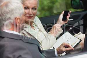 Business people talking together in classy cabriolet