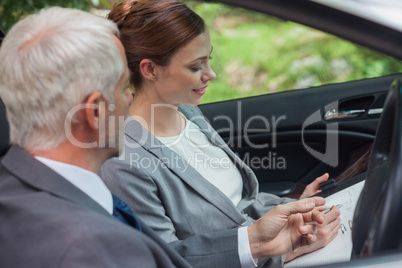 Partners working together in classy car