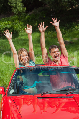 Crazy couple having fun in their cabriolet
