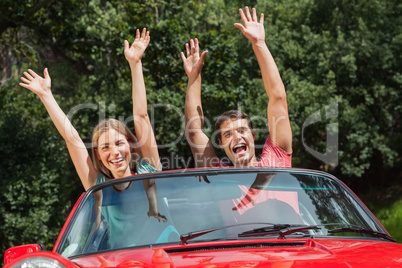 Happy couple having fun in their cabriolet