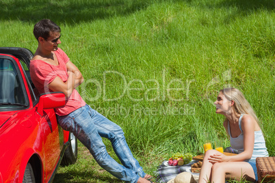 Smiling couple having picnic together