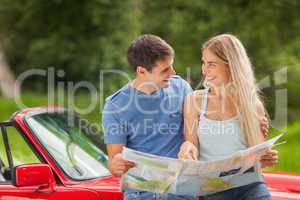 Happy young couple reading map