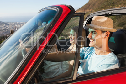Smiling couple on their way to the beach