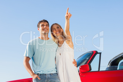 Smiling woman showing something to her handsome boyfriend