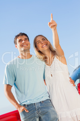 Happy woman showing something to her handsome boyfriend