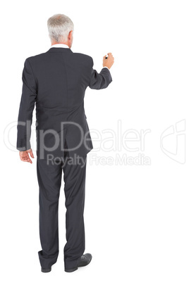 Rear view of businessman standing and writing