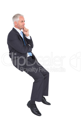 Businessman looking up while thinking