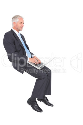 Confident mature businessman working on his laptop