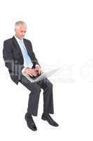 Mature businessman typing on his laptop