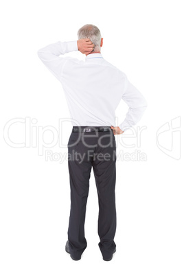 Businessman standing back to camera scratching his head