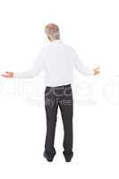 Rear view of surprised mature businessman posing