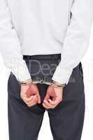 Close up on young businessman wearing handcuffs