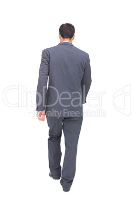 Young businessman walking away from camera