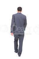 Young businessman walking away from camera