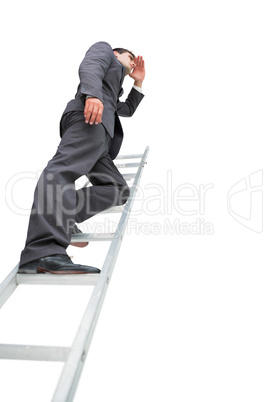 Low angle view of businessman standing on ladder