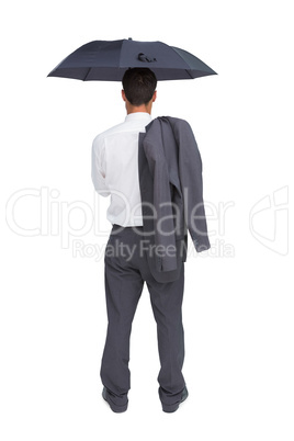 Businessman standing back to camera holding umbrella and jacket