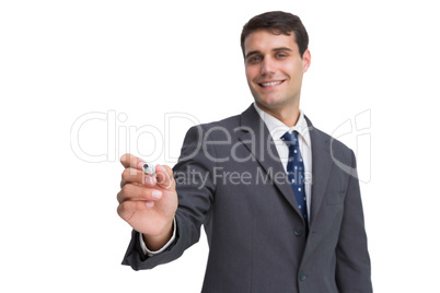 Smiling businessman holding marker and looking at camera