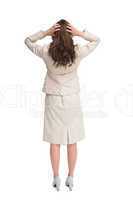 Businesswoman with hands on head standing back to camera