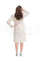 Businesswoman standing back to camera with hand on head