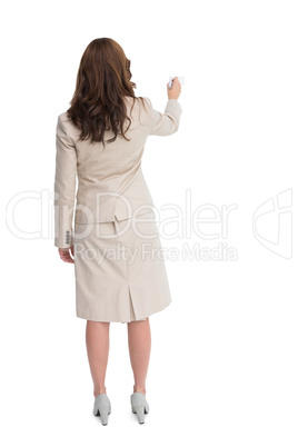 Businesswoman standing back to camera writing with marker