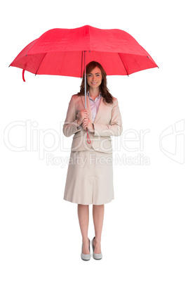 Attractive businesswoman holding red umbrella