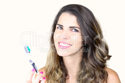 beautiful young lady holding toothbrush and smiling