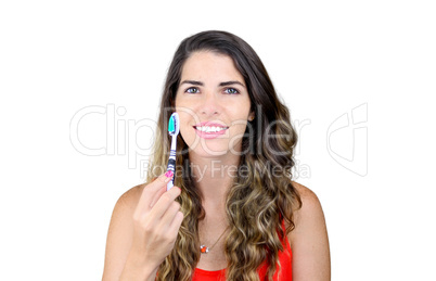 beautiful young woman showing toothbrush and smiling
