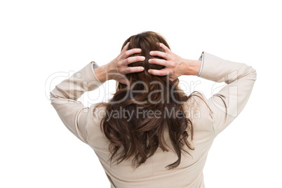 Young classy businesswoman with hands on head standing back to c