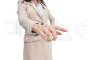 Stylish businesswoman touching invisible screen