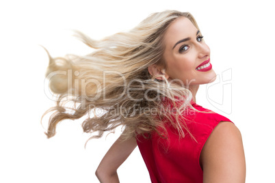 Blonde woman tossing her hair