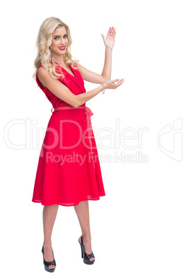 Woman wearing red dress presenting something