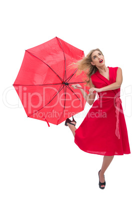 Beautiful woman wearing red dress holding umbrella