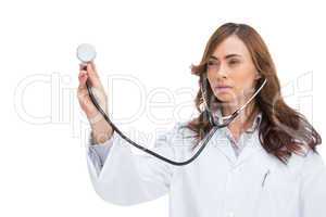 Serious pretty doctor holding stethoscope