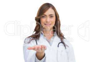 Smiling doctor showing something in her hand