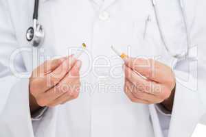 Doctor breaking cigarette