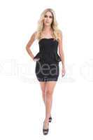 Attractive blonde girl in classy black dress posing