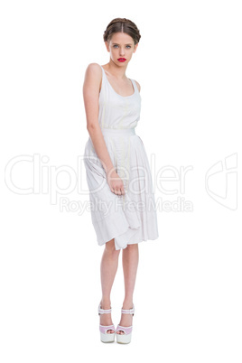 Attractive woman wearing white summer dress standing