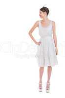 Cheerful pretty woman in white dress posing