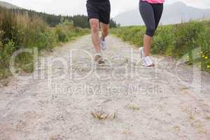 Couples feet running on a trail