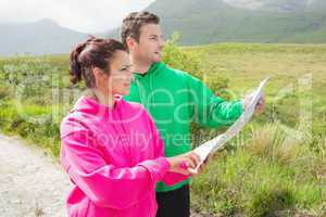 Couples holding a map and looking ahead