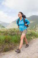 Female hiker with backpack walking