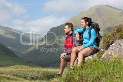 Couple taking a break after hiking uphill