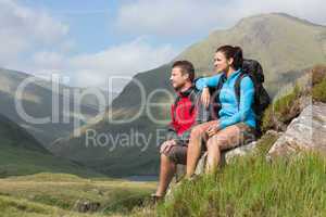 Couple taking a break after hiking uphill