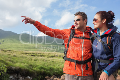 Couple wearing rain jackets and sunglasses admiring the scenery